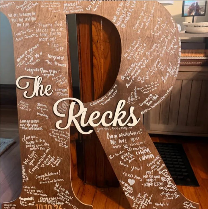 Wooden letter R guest book sign with The Riecks and guest signatures