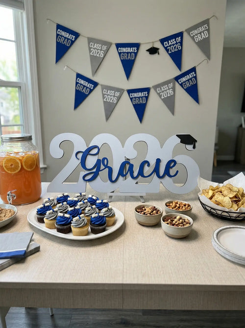 Graduation-themed party setup with '2026 Gracie' sign