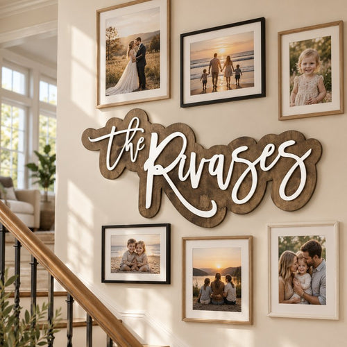 Wooden family name sign on a staircase gallery wall with family photos