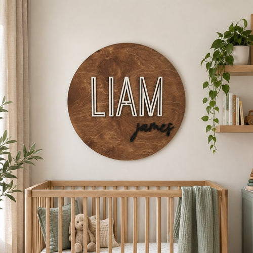 Round wooden baby name sign above a crib in a nursery